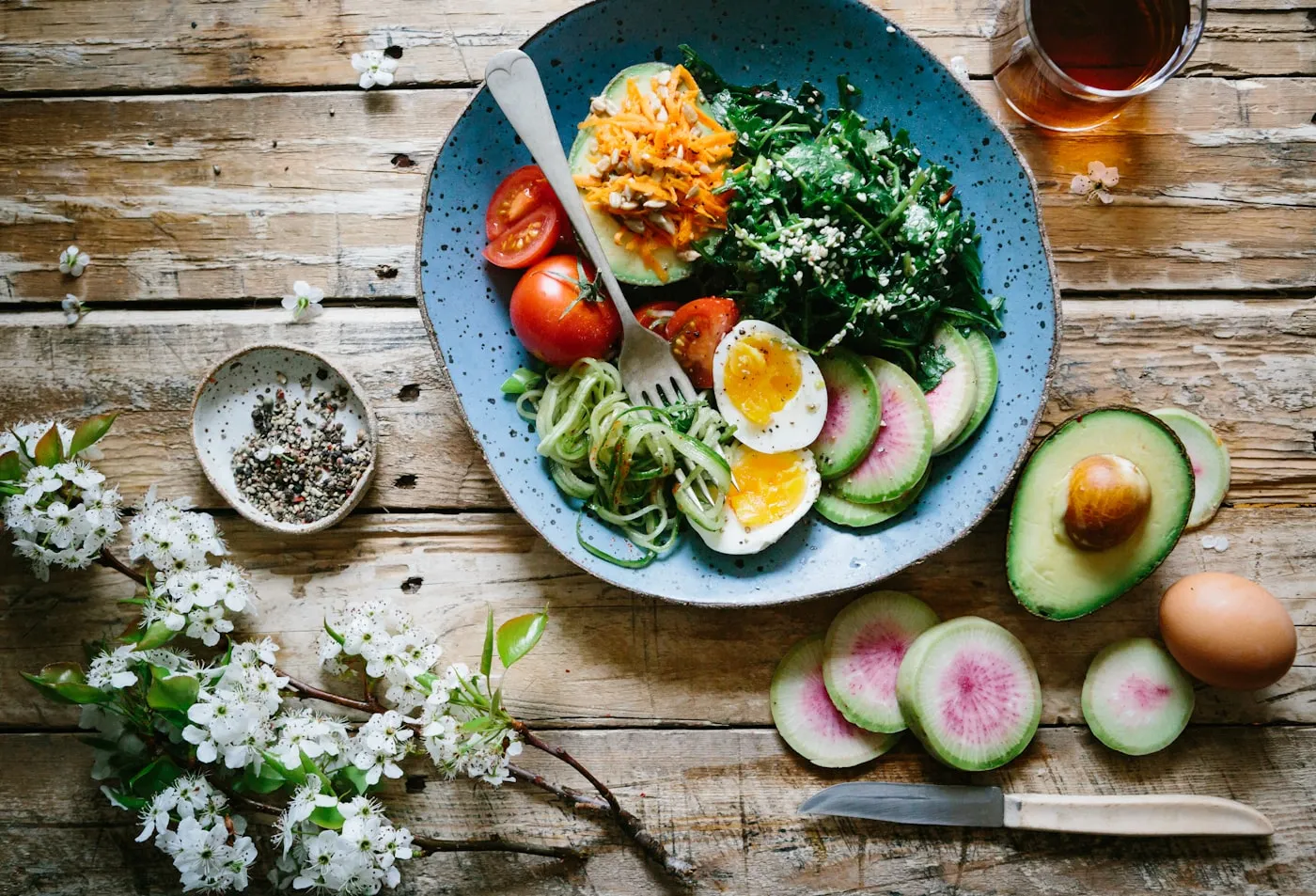 A bowl of fresh food photographed from above on a wooden table